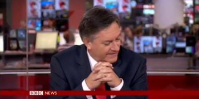 Watch a BBC Newsreader Lose the Will to Live While Reporting on a Dog-Surfing Comp