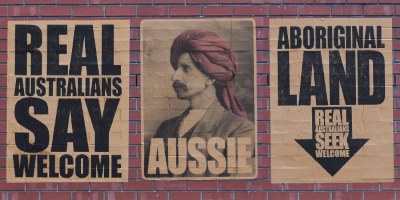 "Real Australians Say Welcome" Artist Debuts His Latest Slogan: "Aboriginal Land"